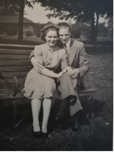 Ronald and Alice sitting on a bench outside 