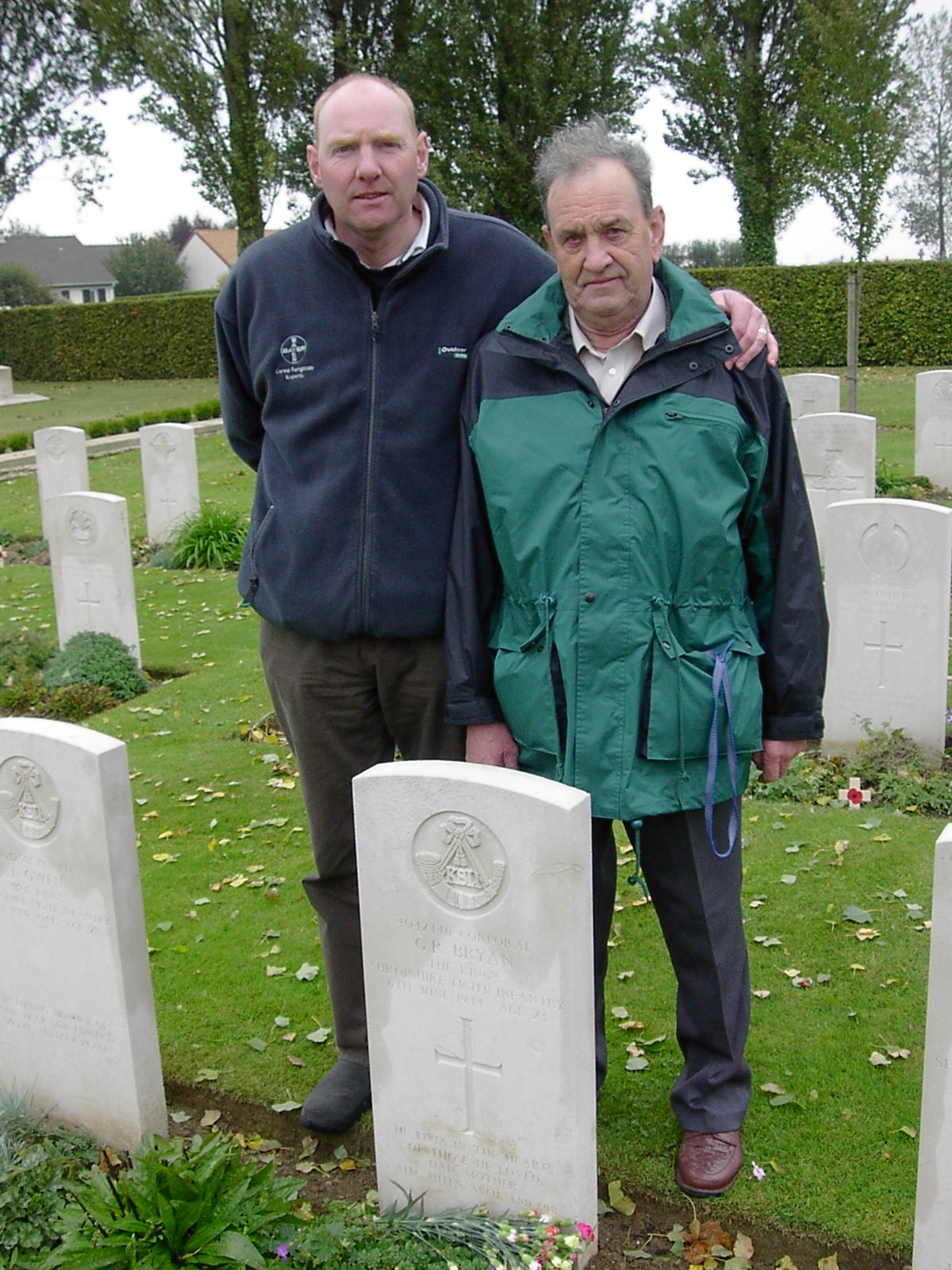 Geoffreys grave stone with Roger Bryan - great nephew - and Richard Bryan - nephew - standing next to each other behind it.